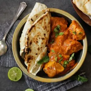 Creamy Butter Chicken served with fresh naan at Garam Masala Indian and Sweets, Edmonton