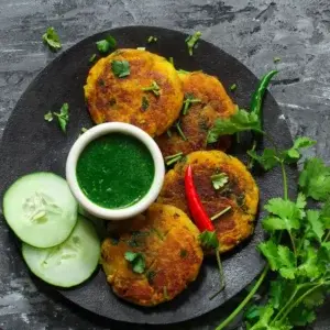Crispy Aloo Tikki served with fresh mint chutney at Garam Masala Indian and Sweets, Edmonton