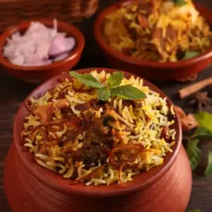 Aromatic biryani slow-cooked in a traditional clay pot at Garam Masala Indian and Sweets, Edmonton